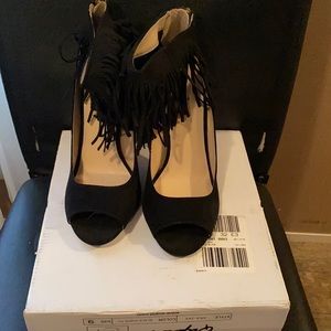 Black suede heels with fridges.